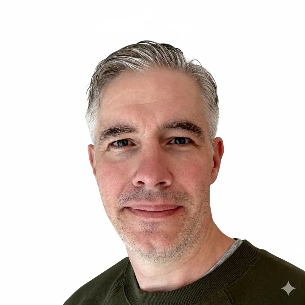 Professional headshot of Phil Thomas, a technology consultant with 25 years of experience in AI and automation for Professional Services businesses